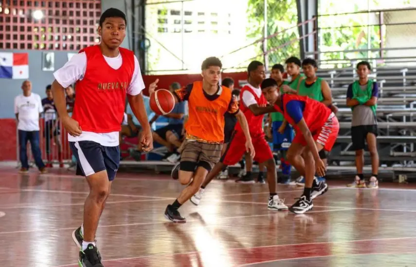 Youth basketball players training on an indoor court in Panamá, from the Encestando Sueños programme